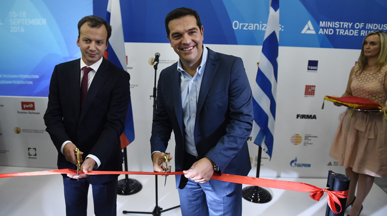 Greece’s Alexis Tsipras, centre, and Russia’s Arkady Dvorkovich at the trade fair in Thessaloniki. (PA)