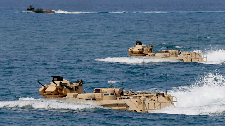 US Navy amphibious assault vehicles perform a combined assault exercise near one of the contested islands in the South China Sea. (PA)