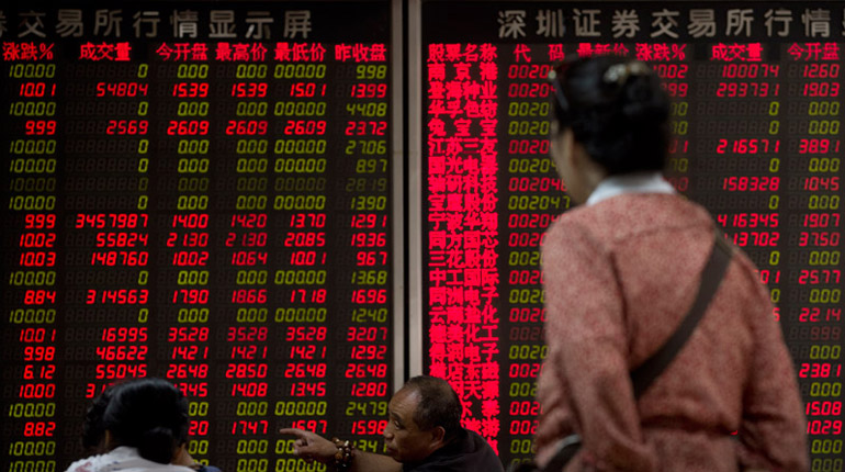 Chinese investors monitoring stock prices at a brokerage house in Beijing. While the prospect of a Grexit has grabbed the headlines recently, a potentially bigger crisis in China could be a greater threat to energy markets. (PA)