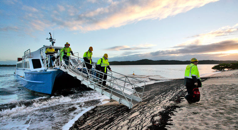 Contractors disembark at Curtis Island, location of Origin’s Australia Pacific LNG project. (APLNG)