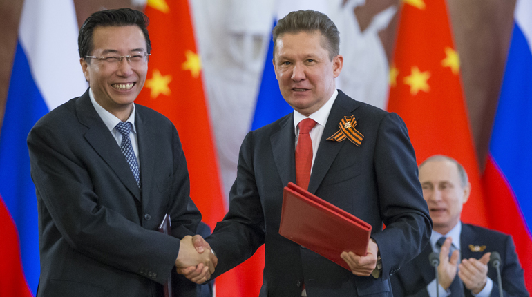 Wang Dongjin (left), vice president of CNPC, with Gazprom’s CEO Alexei Miller at the signing of the agreement. (PA)