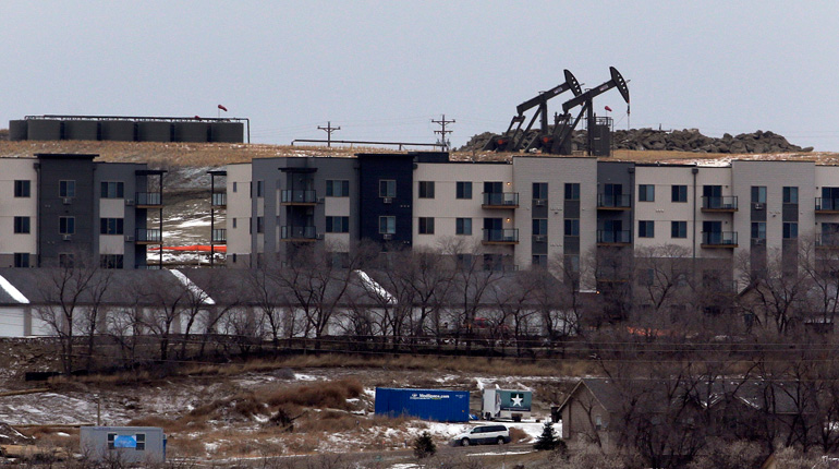 Oil pump jacks in North Dakota. Output has slowed as oil prices have dropped. (PA)