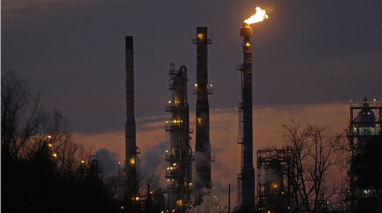 Flaring at an Exxon refinery in Louisiana. Shareholders voted against stronger rules to do with climate change. (PA)