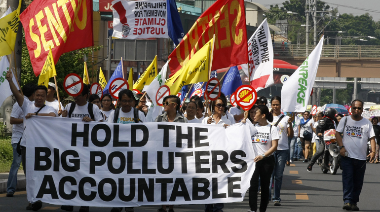 Protesters march on the Philippines’ Commission on Human Rights to file their complaint. (PA)