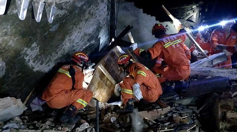 Rescuers search collapsed buildings in Changning county following the earthquake.