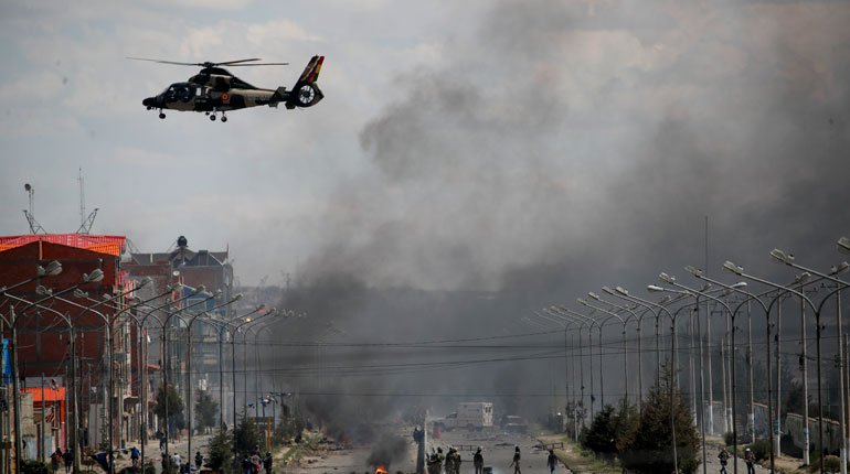 Helicopter flying over Morales supporters outside a La Paz fuel plant