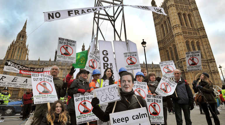Demonstrators erect a seven meter high 'fracking rig' as they call for a ban on exploration and development of shale gas in the UK, outside the Houses of Parliament, London.